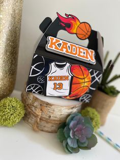 a basketball themed card holder next to some succulents