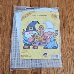 a plastic bag with an image of two gnomes and a basket of pumpkins