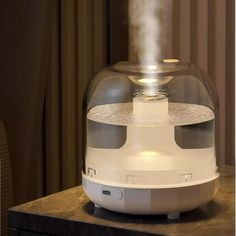 a humidifier sitting on top of a table next to a window