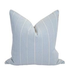 a blue and white striped pillow on a white background