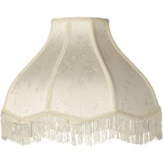 a white lamp shade with fringes on it