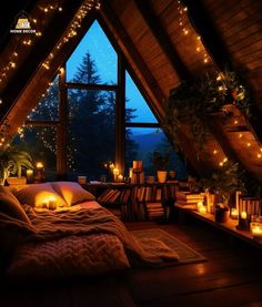 an attic bedroom with candles and lights on the windowsill, bed in foreground