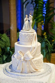 a wedding cake with two people on top