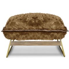 a fur covered bench with wooden legs