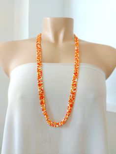 "This delicate necklace is made with orange shades of seed beads: orange, peach and ivory. Available at checkout in 7 different lengths, from choker to extra long. Size shown in the picture is 30 inches. ❤ SIZES This item comes in several sizes, kindly choose at checkout. The easiest way to find out which length suits you best is to measure a necklace you already own, from one end to the next, including clasp. You can also use the diagram on the pictures as a reference, but keep in mind that we Boho Orange, Orange Dreamsicle, Peach Necklace, Orange Shades, Orange Necklace, Necklace Beaded, Seed Bead Necklace, Multi Strand Necklace, Shades Of Orange