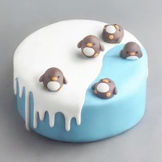 a cake decorated with penguins and melting icing