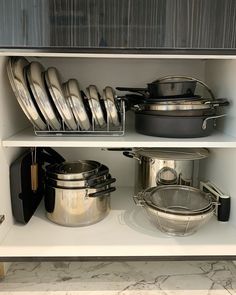 pots and pans are sitting on the shelves