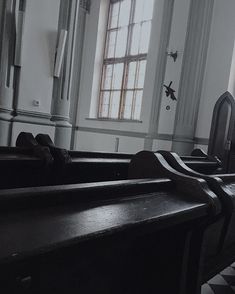 an empty church with pews in the foreground