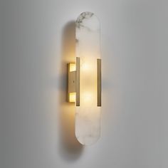 a wall light that is mounted to the side of a wall with two lights on it