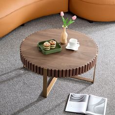 a table with some food on it and a vase filled with flowers in the middle