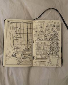 an open notebook with drawings on it