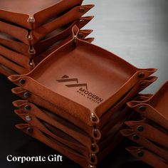 a stack of brown leather trays sitting on top of each other