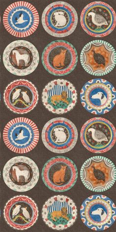 several plates with animals on them in different colors and sizes, all decorated with designs