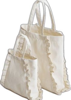 three white bags with ruffles on them