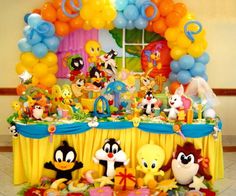 a table with balloons and stuffed animals on it