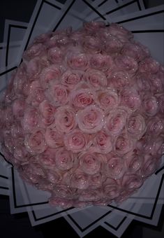 a bouquet of pink roses on top of a white plate