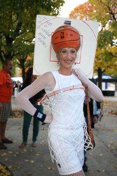 a woman with a basketball hat and net on her head is posing for the camera