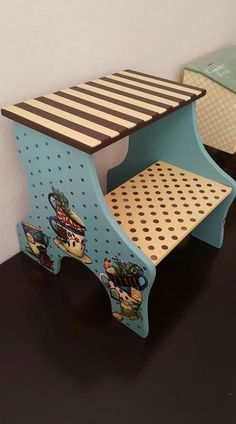 two wooden step stools sitting next to each other on a black floor with polka dots