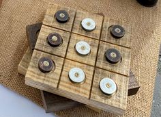 several wooden boxes with buttons on them sitting on top of burlocked cloth