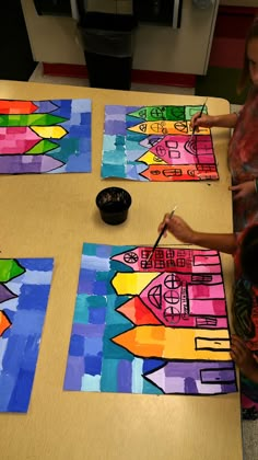 two children are making art with colored paper