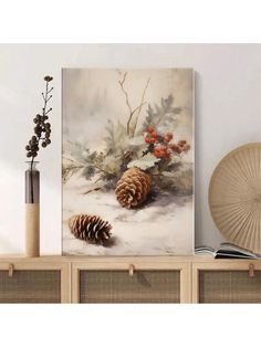 a painting with pine cones and berries on the shelf next to a vase filled with flowers