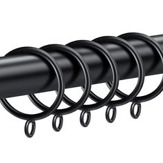 four black rings hang from the side of a metal rod, with one ring on each end