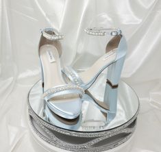 Blue satin Wedding Shoes with Sparkling Crystal and Pearl Trim Design are available in over 100 colors!  Sparkle with each step you take.  These beautiful shoes have a chunky heel and front platform.  These shoes are available in over 100 different colors including ivory, eggplant, David's Bridal Colors, as well as the option of sending us a sample swatch to color match for you!  The listing color picture has been dyed Baby Blue. The beautiful shoes have an approximate 4 1/8th inch block heel with a platform in the front of the shoe which is approximately 3/8th of an inch. * All dyed shoes can bleed when exposed to moisture. If you would like to protect your shoes please consider purchasing my water repellent service. You can chose this option from the above drop down menu when you are pic Light Blue Quince Shoes, Blue Heels With Pearls, Light Blue Heels Wedding, Sky Blue Heels, Blue Wedding Heels, Light Blue High Heels, Platform Bridal Shoes, Platform Wedding Shoes, Bridal Colors