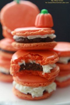 there is a stack of cookies that are decorated like pumpkins