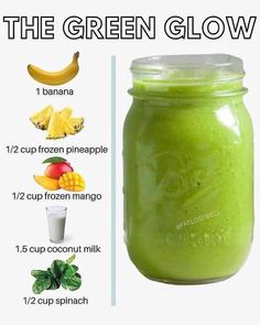 a green smoothie in a mason jar with ingredients to make it