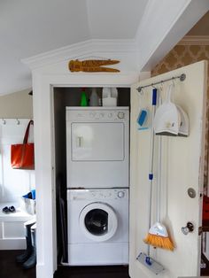 there is a washer and dryer in this small room with the door open