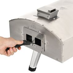 a person is using an electric meat slicer to cut into something with a knife