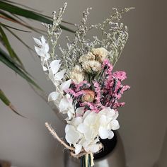 a vase filled with white and pink flowers