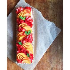 a piece of fruit cake sitting on top of a wooden table