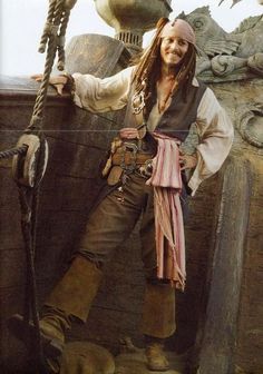 a man dressed in pirate clothing posing for the camera