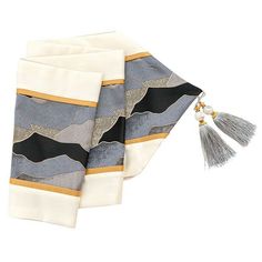 two pieces of cloth with tassels on them