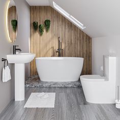 a white bath tub sitting next to a toilet under a bathroom mirror on top of a wooden wall