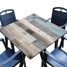 a wooden table with blue chairs around it and an empty chair next to it on a white background