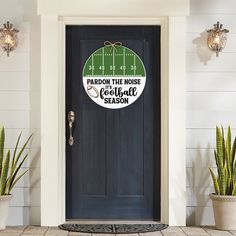 a front door with a sign that says pardon the noise football season