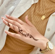 a woman's hand with a tattoo on it