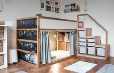 there is a loft bed that has been built into the wall with chalkboard on it