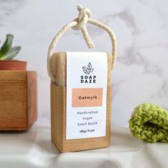 a soap bar sitting on top of a counter next to a potted plant