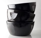 three black bowls stacked on top of each other