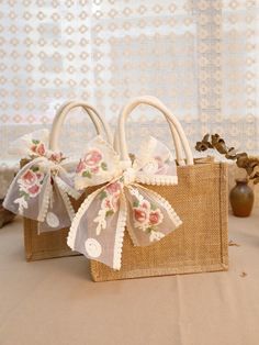 two bags with bows are sitting on a table