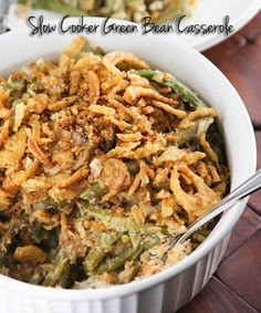 two white bowls filled with green bean casserole on top of a wooden table