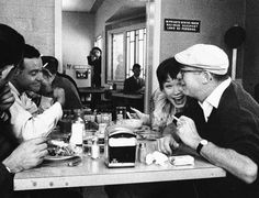 a group of people sitting around a table eating food