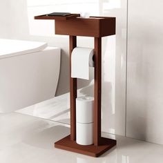 a toilet paper dispenser sitting on top of a wooden stand in a bathroom