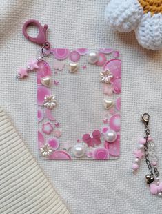 a pink and white photo frame sitting on top of a table next to a pair of scissors