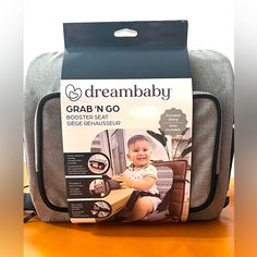 a baby sitting in a chair with its back pack on top of the bag and it's packaging