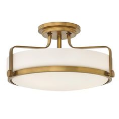 a semi flush light fixture with white glass shades on the bottom and gold trimmings