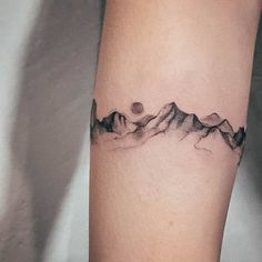 a black and white photo of a mountain tattoo